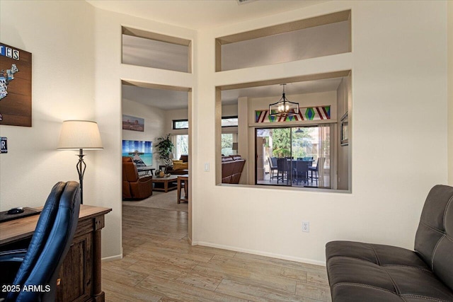 interior space with light wood-type flooring and baseboards