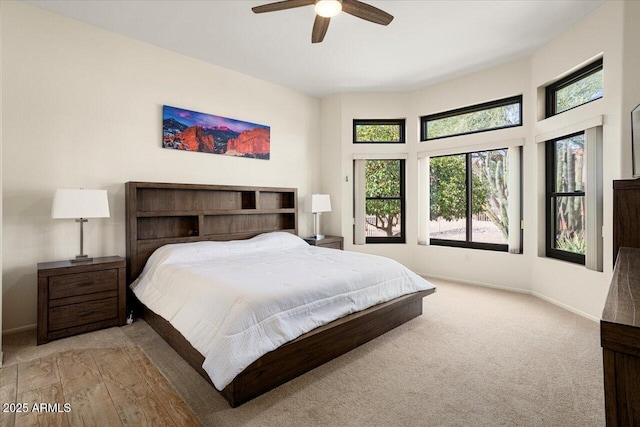 bedroom with a ceiling fan and baseboards