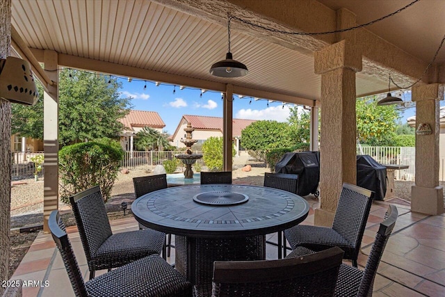 view of patio / terrace featuring outdoor dining area, a grill, and fence