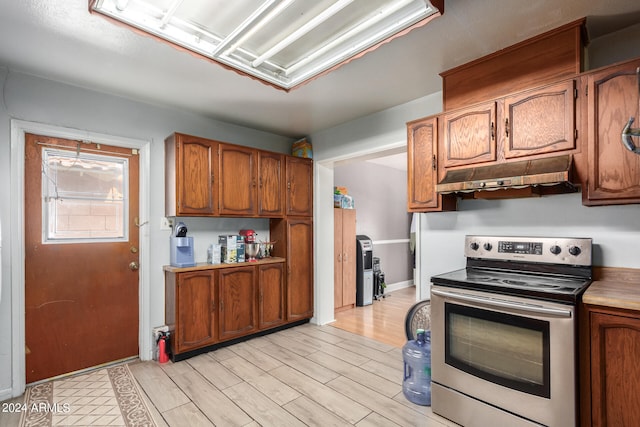 kitchen featuring light hardwood / wood-style flooring and stainless steel range with electric cooktop