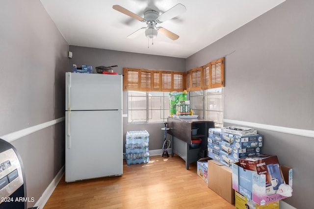 interior space with light hardwood / wood-style flooring, ceiling fan, and white fridge