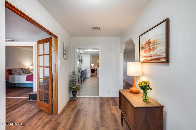 hallway with french doors and dark hardwood / wood-style floors