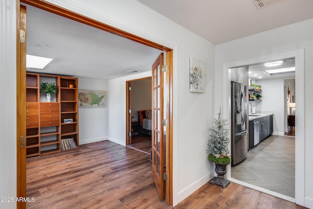 hallway with sink and dark hardwood / wood-style flooring