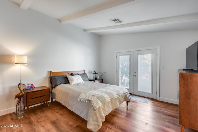 bedroom featuring access to outside, wood-type flooring, french doors, and beamed ceiling