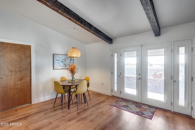 doorway to outside with beam ceiling, french doors, and light hardwood / wood-style floors