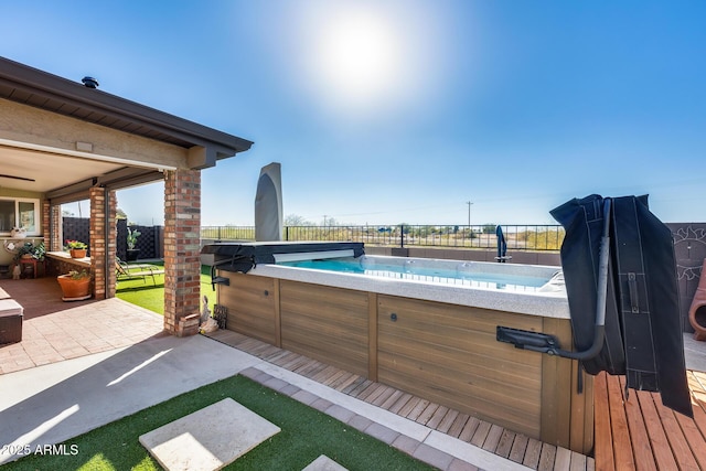 view of swimming pool featuring a hot tub