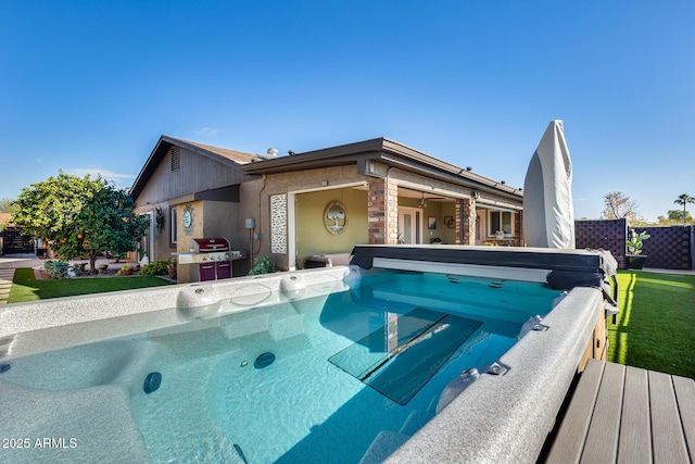 view of pool featuring a hot tub and a grill