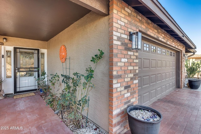 view of exterior entry featuring a garage