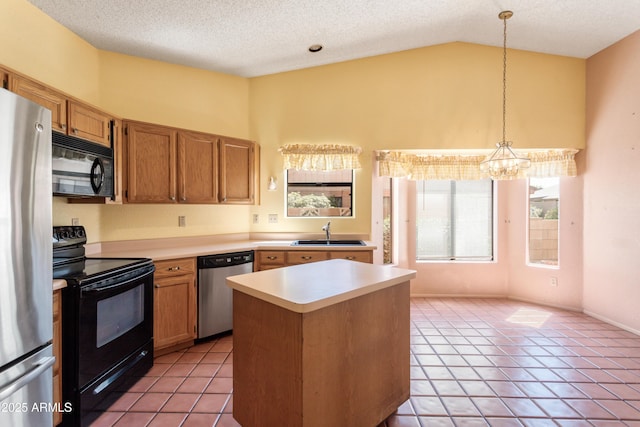 kitchen featuring vaulted ceiling, black appliances, light tile patterned flooring, light countertops, and a sink