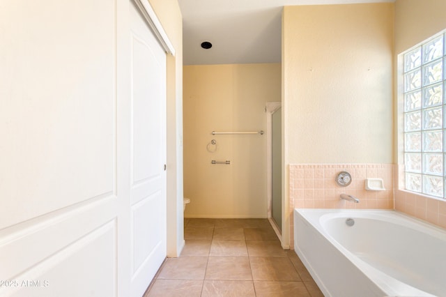 full bath with a shower stall, a bath, tile patterned flooring, and plenty of natural light