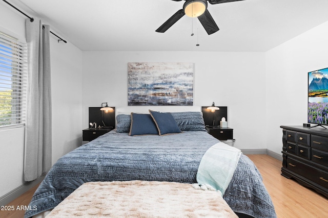 bedroom with ceiling fan and light wood-type flooring