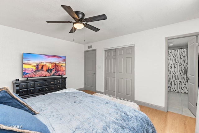 bedroom with a closet, ceiling fan, light hardwood / wood-style floors, and a textured ceiling