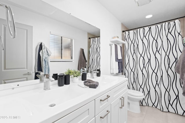 bathroom featuring vanity, tile patterned floors, and toilet