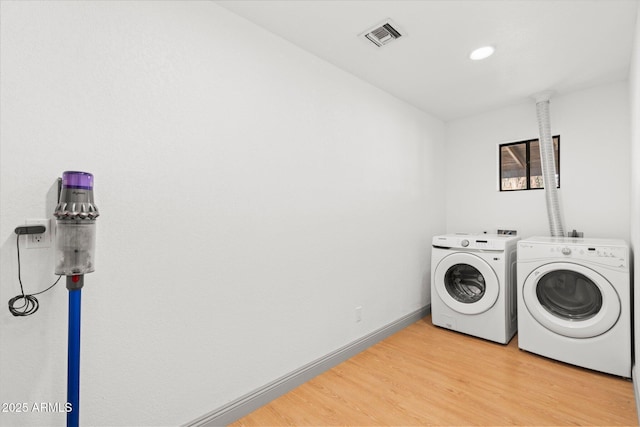 washroom featuring independent washer and dryer and light wood-type flooring