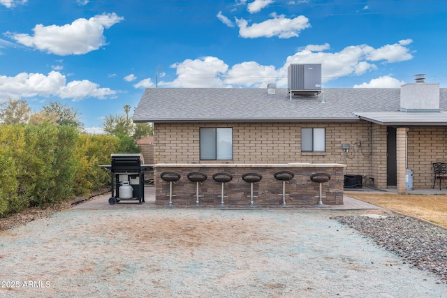 view of patio featuring a grill and central AC unit