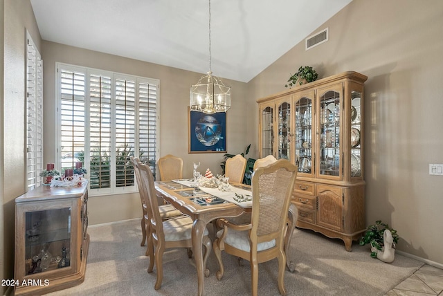 dining room with lofted ceiling, a chandelier, visible vents, and baseboards