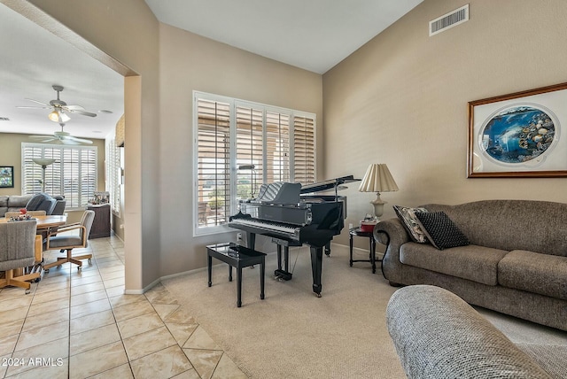 interior space with a healthy amount of sunlight, ceiling fan, and light colored carpet