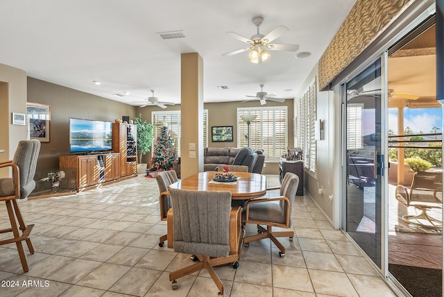 dining space with ceiling fan and light tile patterned floors