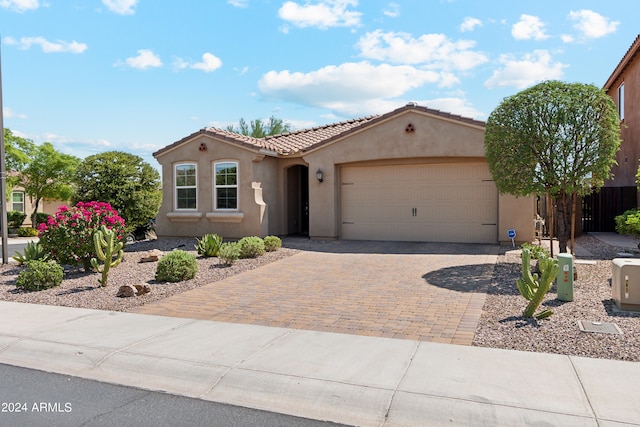 mediterranean / spanish-style home with a garage