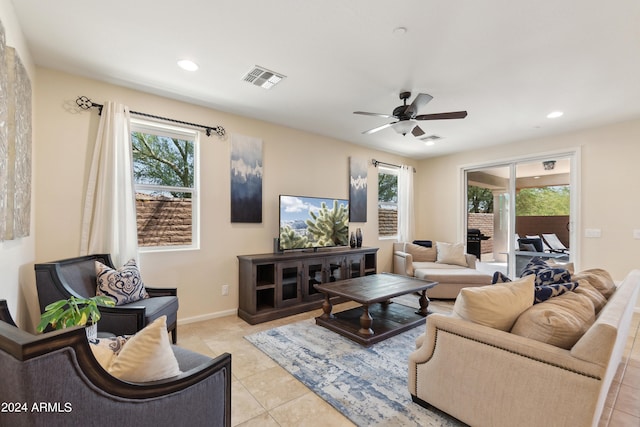 tiled living room featuring ceiling fan