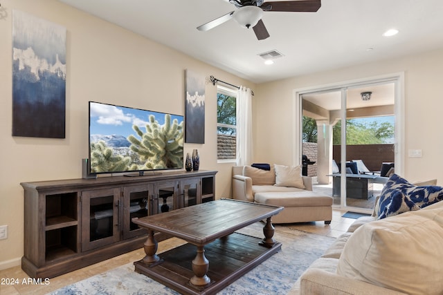 tiled living room featuring ceiling fan