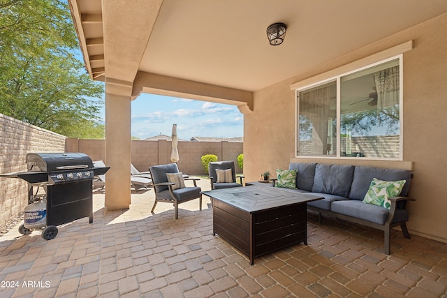 view of patio featuring a grill and an outdoor living space with a fire pit