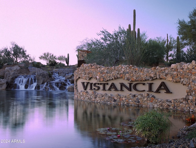 community / neighborhood sign featuring a water view