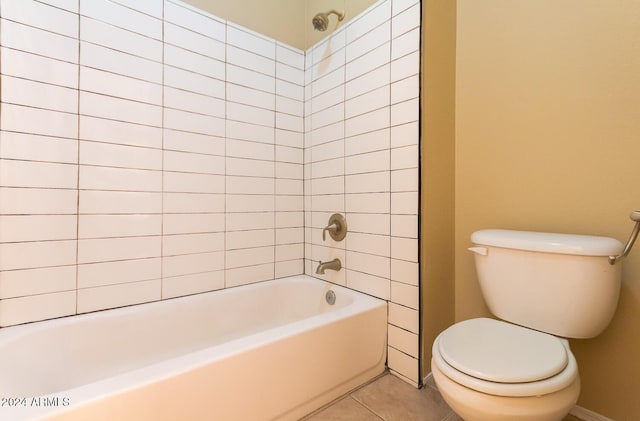 bathroom featuring toilet, tiled shower / bath combo, and tile patterned floors