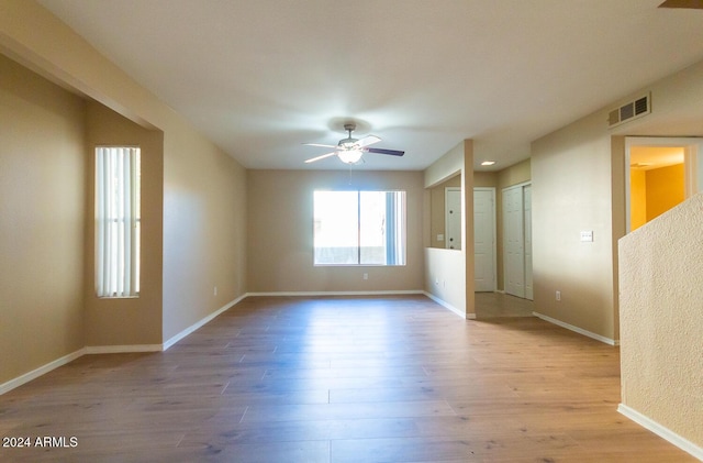 empty room with light hardwood / wood-style flooring and ceiling fan