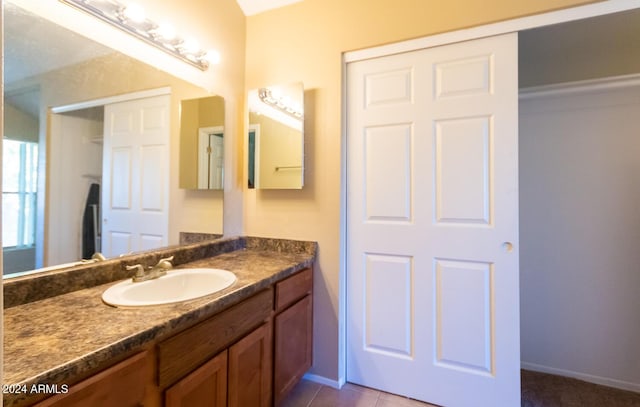 bathroom with tile patterned flooring and vanity