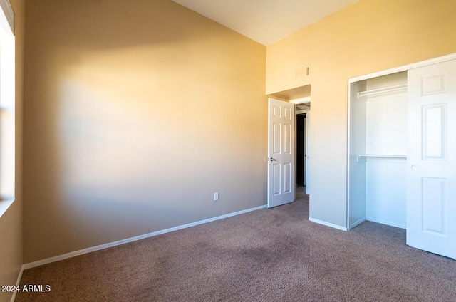 unfurnished bedroom featuring carpet flooring and a closet