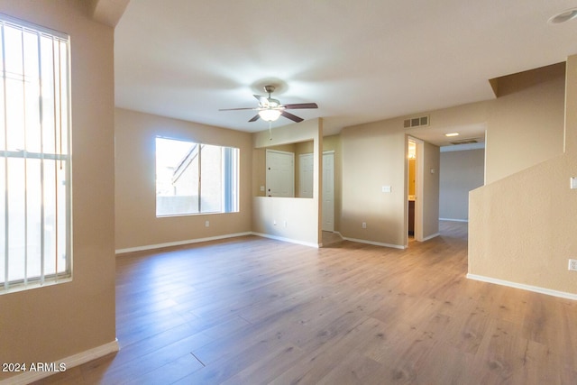 unfurnished room featuring ceiling fan and light wood-type flooring