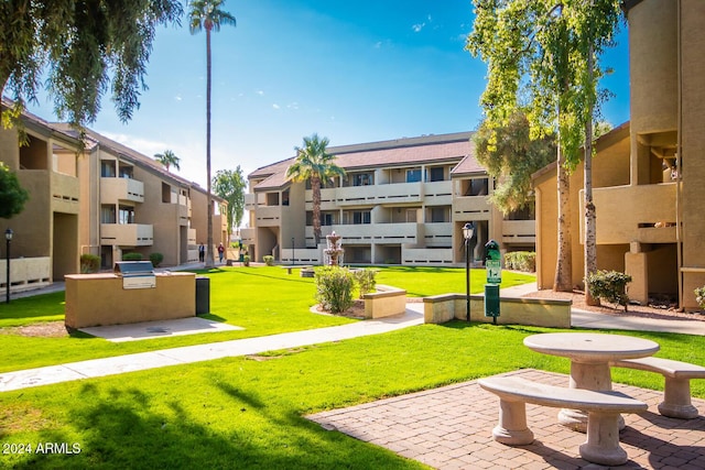 view of property's community featuring exterior kitchen and a yard