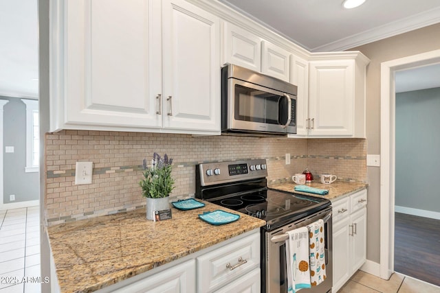 4427 W Crittenden Ln, Phoenix, AZ 85031 - kitchen featuring appliances with stainless steel finishes, light tile patterned floors, ornamental molding, baseboards, and white cabinets