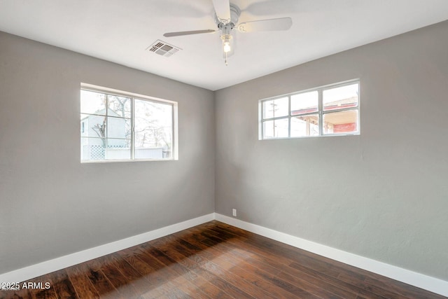 4427 W Crittenden Ln, Phoenix, AZ 85031 - empty room with baseboards, dark wood finished floors, and a ceiling fan