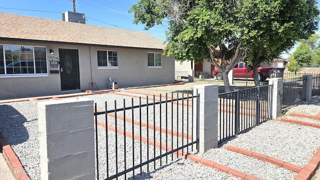 4427 W Crittenden Ln, Phoenix, AZ 85031 - view of front of property featuring roof with shingles, a fenced front yard, and stucco siding