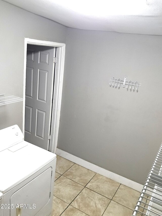 4427 W Crittenden Ln, Phoenix, AZ 85031 - laundry area with washer / dryer, light tile patterned floors, and baseboards