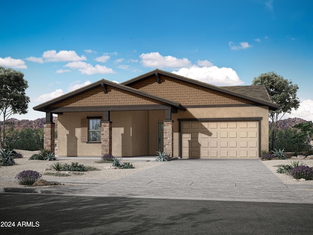 view of front of house with stucco siding, decorative driveway, and a garage