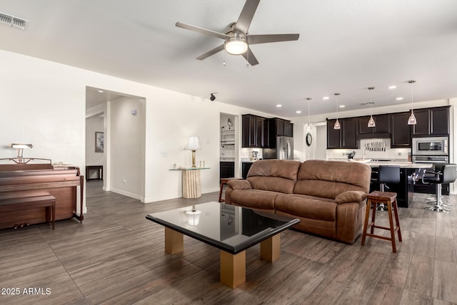 living room with wood finished floors, visible vents, recessed lighting, ceiling fan, and baseboards
