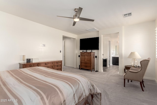 bedroom with light colored carpet, ensuite bathroom, baseboards, and visible vents