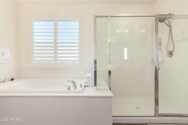 bathroom with a shower stall and a garden tub
