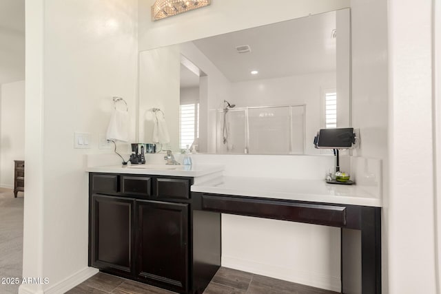 full bathroom with a shower stall, baseboards, vanity, and wood finished floors