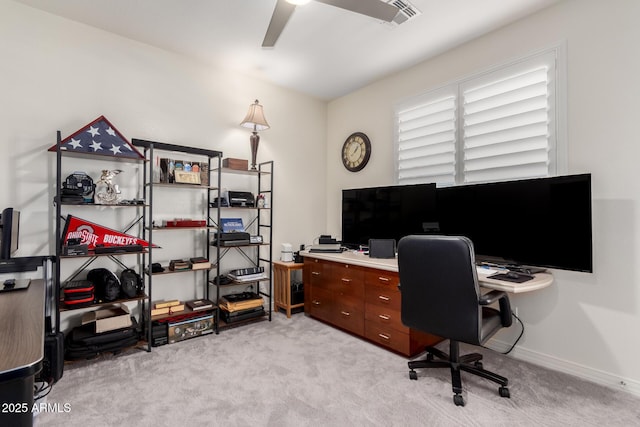 office space featuring light carpet, baseboards, a ceiling fan, and visible vents