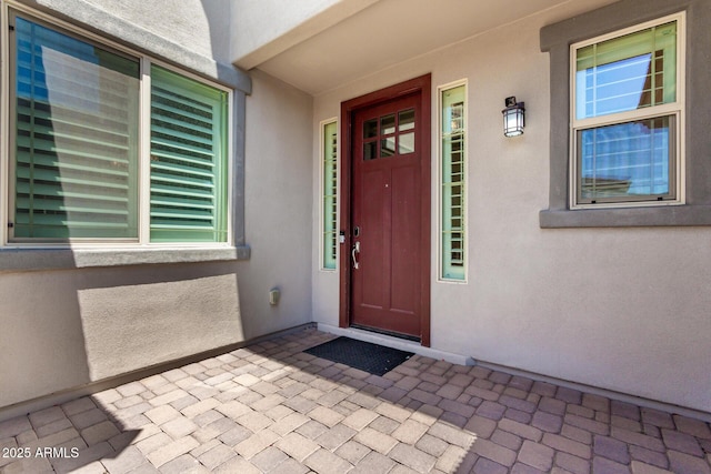 property entrance featuring stucco siding
