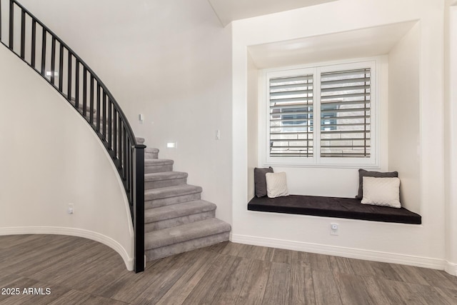 stairs with wood finished floors and baseboards