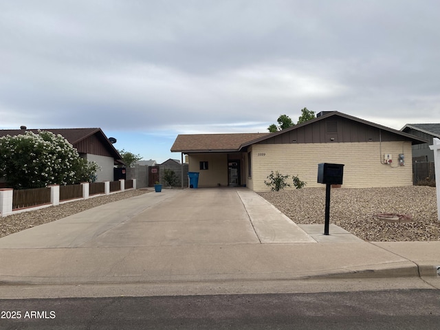 3229 W Cholla St, Phoenix, AZ 85029 - ranch-style house with driveway, board and batten siding, and brick siding