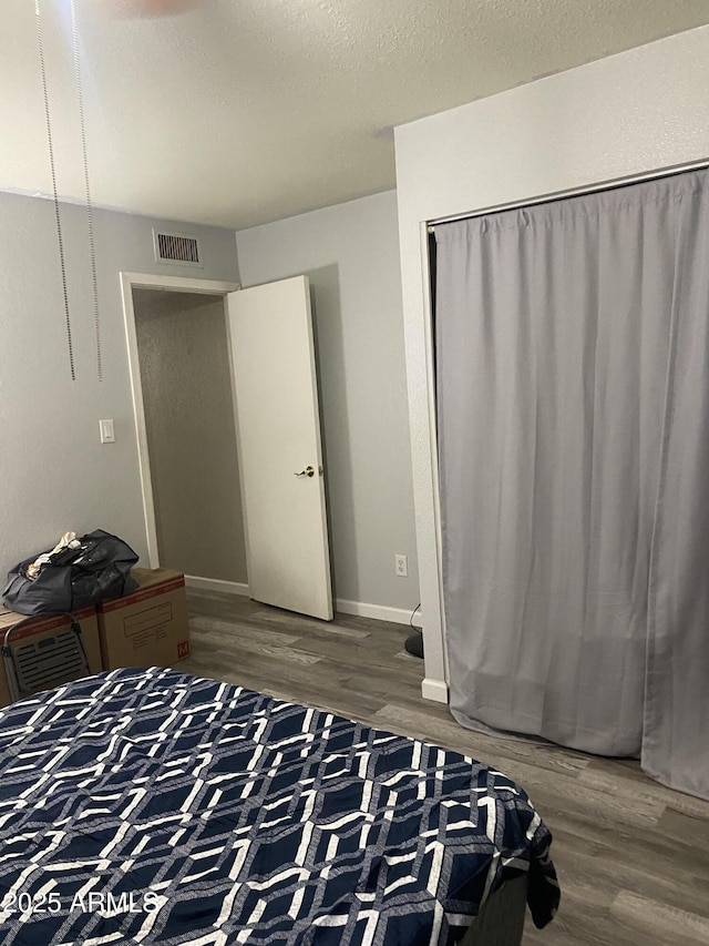 3229 W Cholla St, Phoenix, AZ 85029 - bedroom with wood finished floors, a textured ceiling, and baseboards