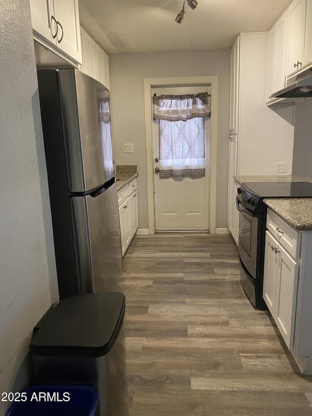 3229 W Cholla St, Phoenix, AZ 85029 - kitchen with appliances with stainless steel finishes, wood finished floors, white cabinets, and under cabinet range hood