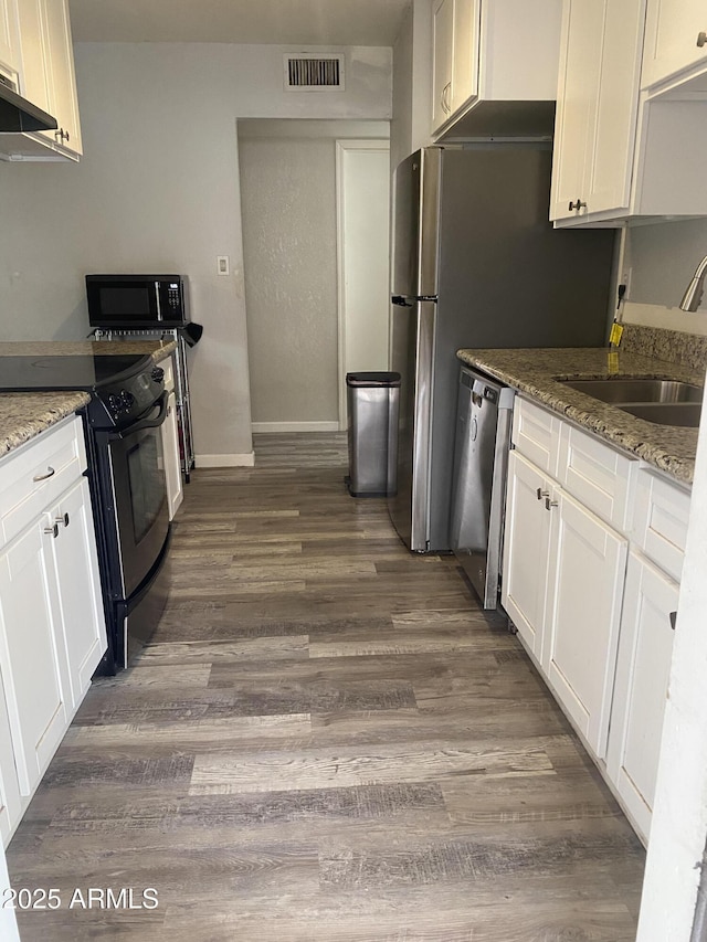3229 W Cholla St, Phoenix, AZ 85029 - kitchen featuring black appliances, dark wood-style floors, a sink, and white cabinetry