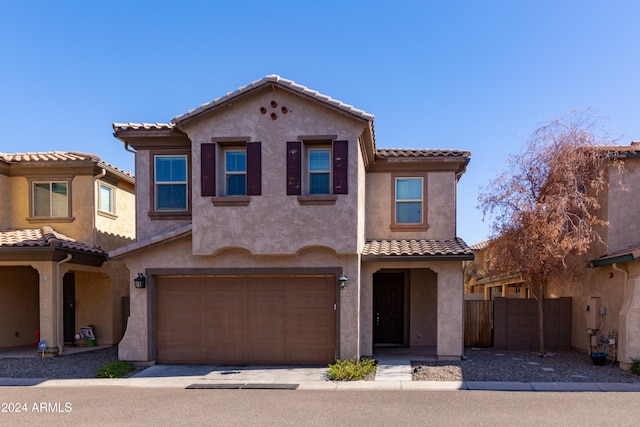 mediterranean / spanish house with a garage